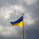 a blue and yellow flag on a flagpole