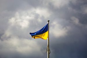 a blue and yellow flag on a flagpole